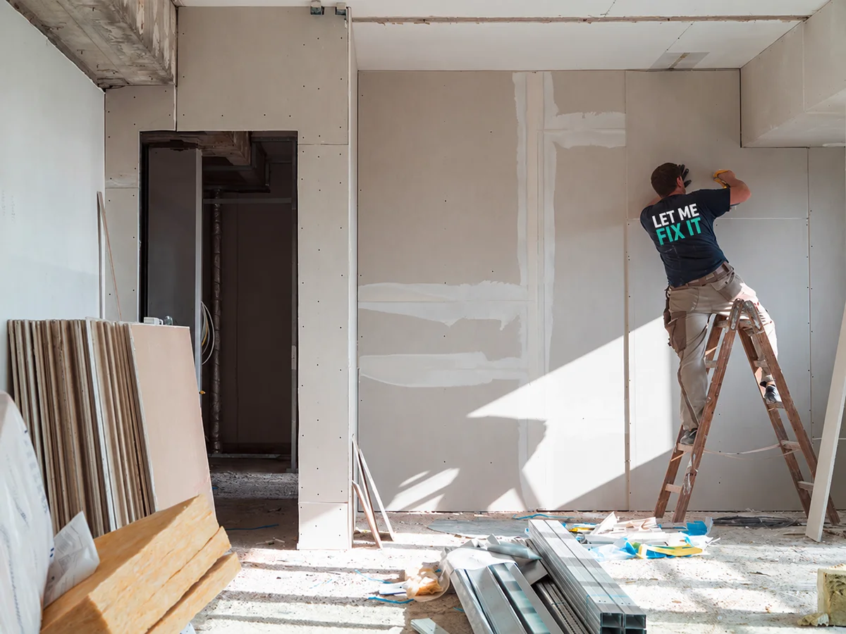 Drywall installer working inside a renovation project
