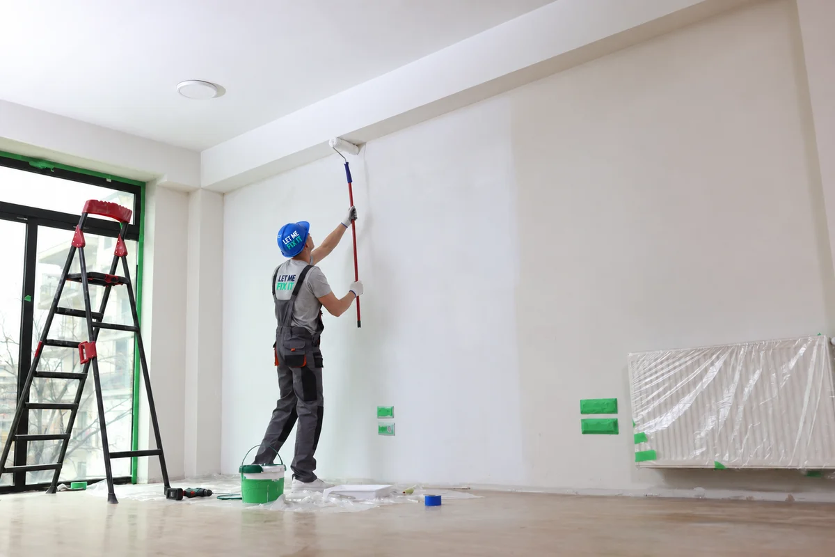 Professional painter applying paint during an interior renovation